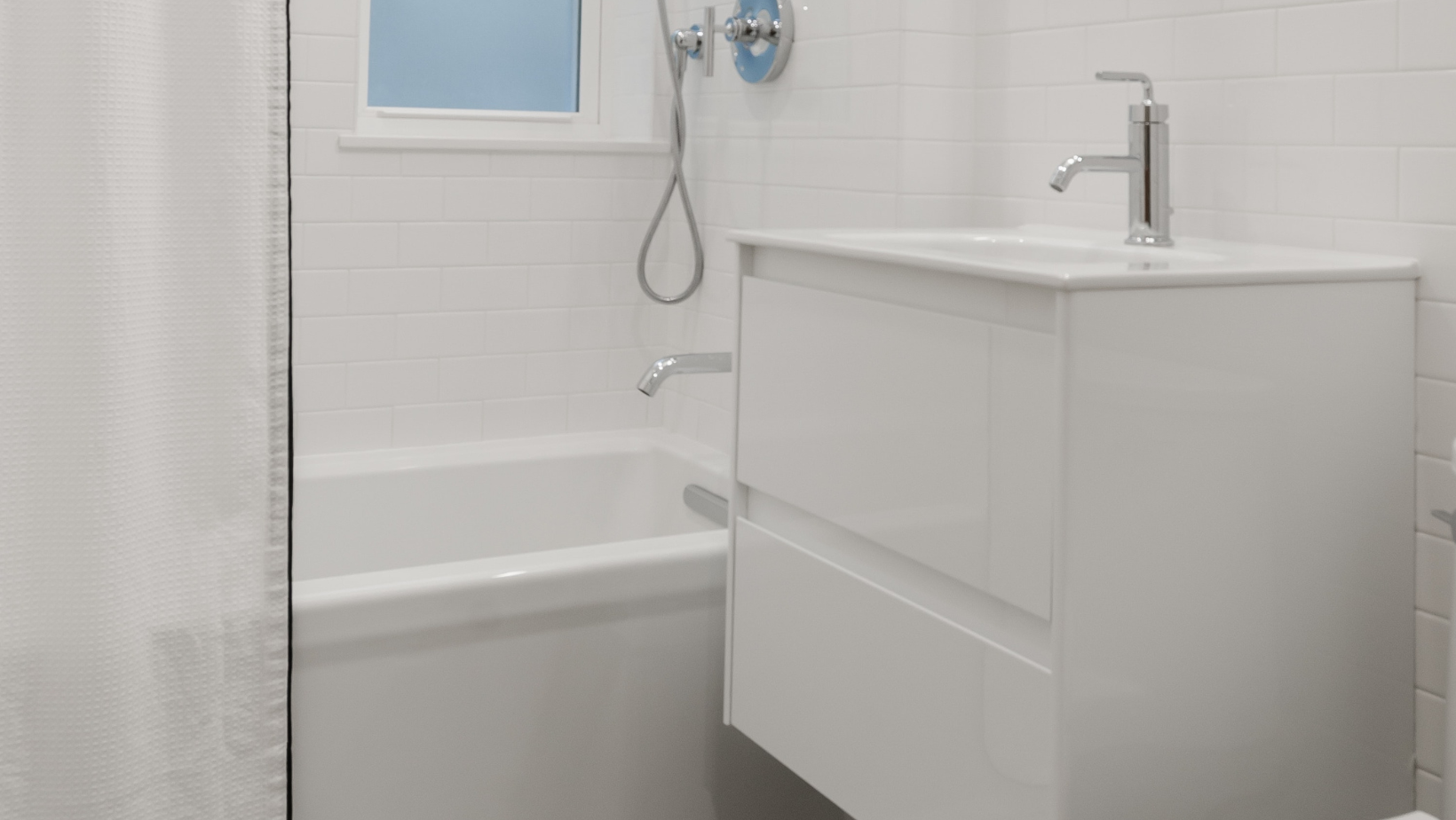 A clean white vanity paired with a white wall can dramatically increase the space perception of your small bathroom.