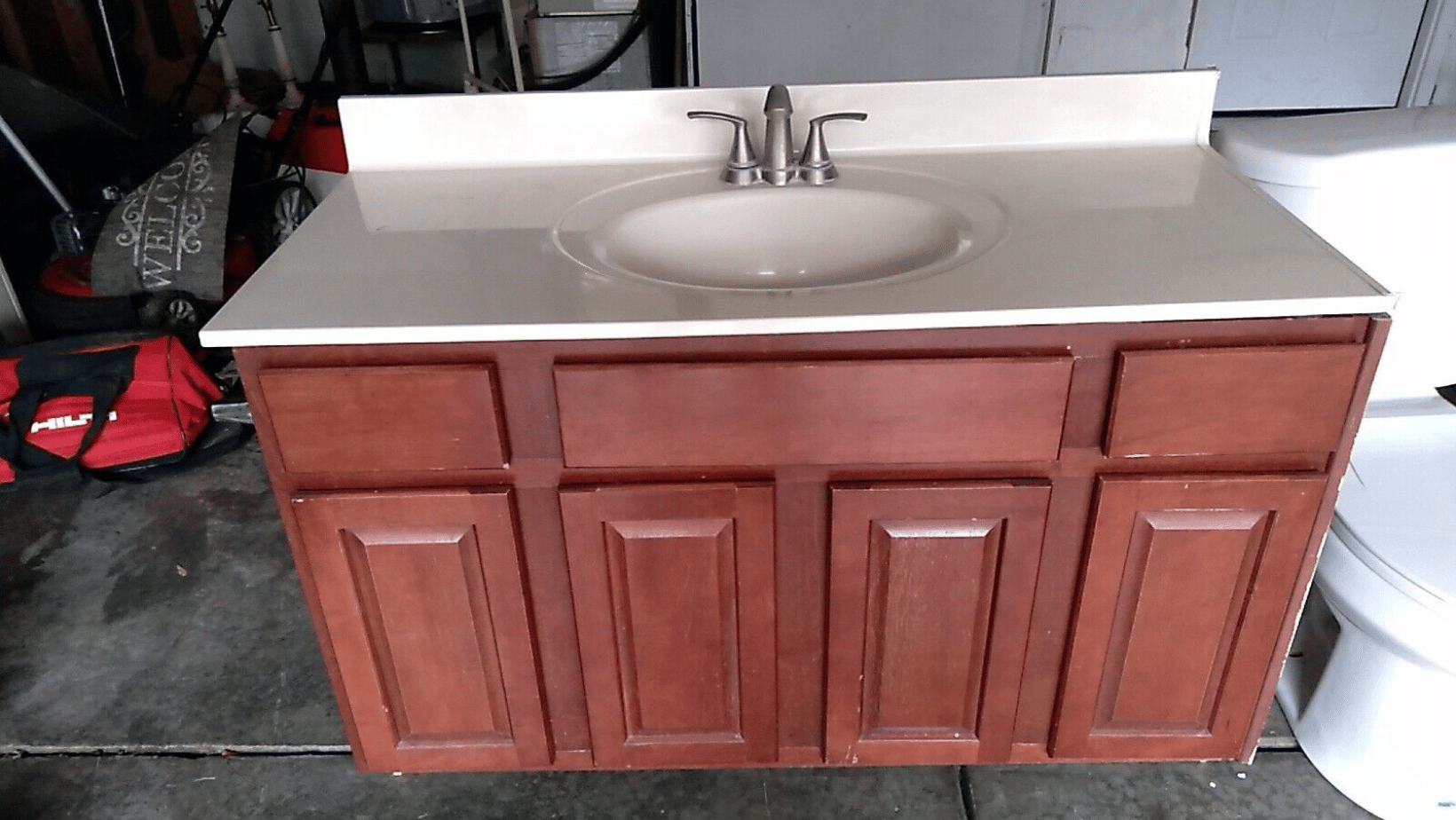 Minor vanity chips, cracks and stains on a moderately good condition used bathroom vanity.